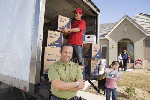 Local movers loading boxes and furniture into a van in Switzerland